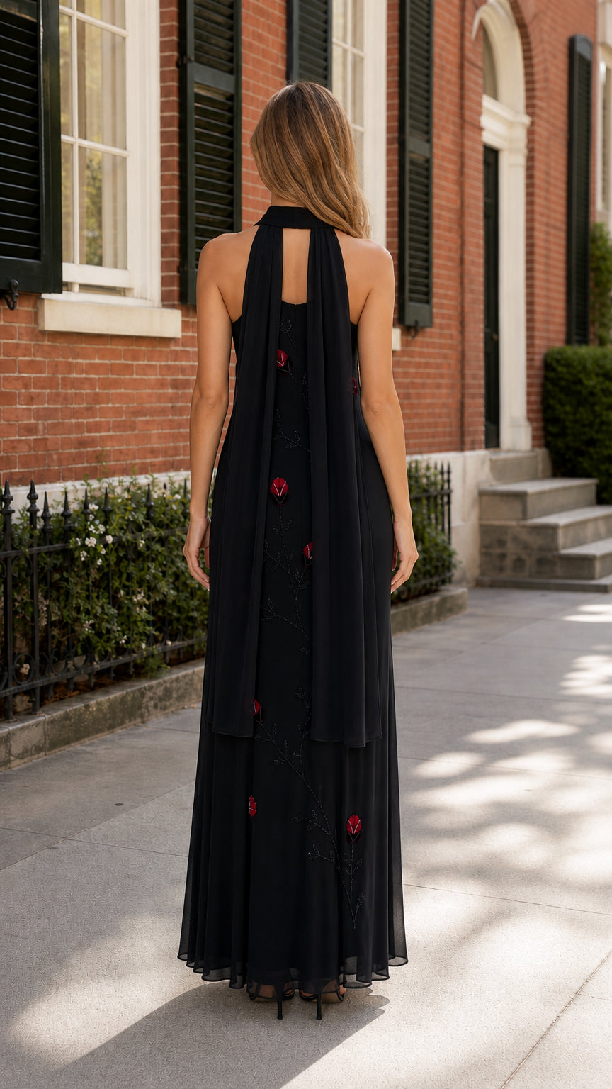 Back view of black halter maxi dress showing draped panels