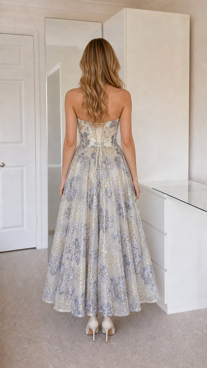 Back view showcasing corset lacing on champagne dress