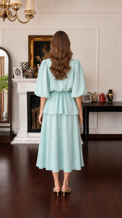 Model wearing mint green midi dress, back view