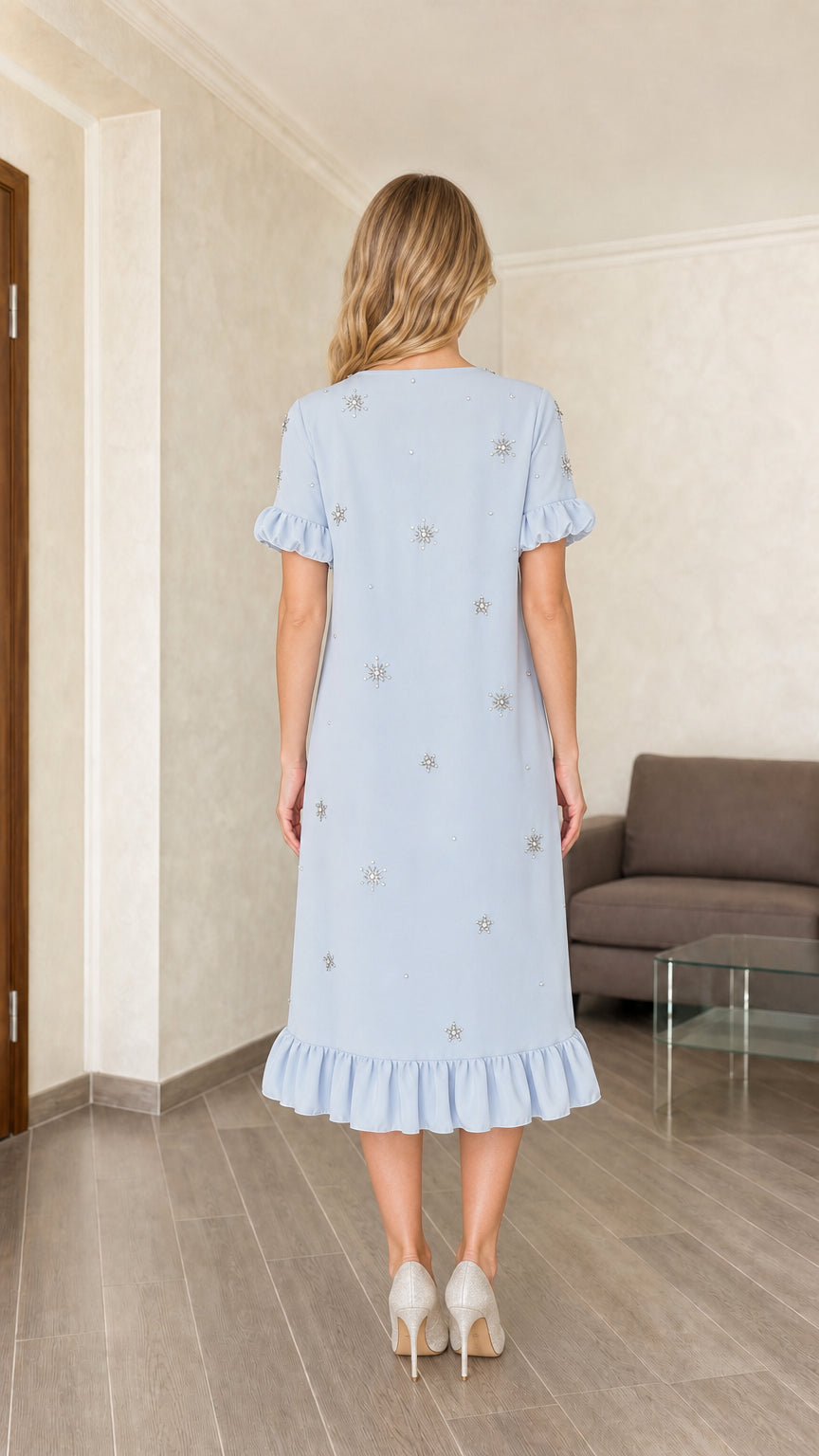 Model wearing light blue embellished midi dress, back view