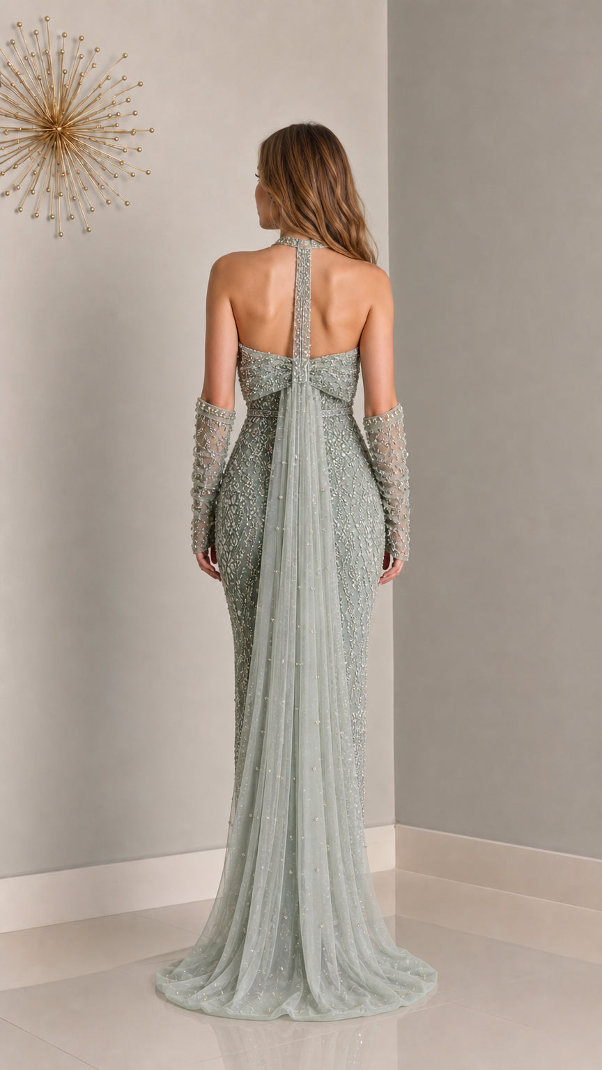 Back view of sage green evening gown showing open back and cape train