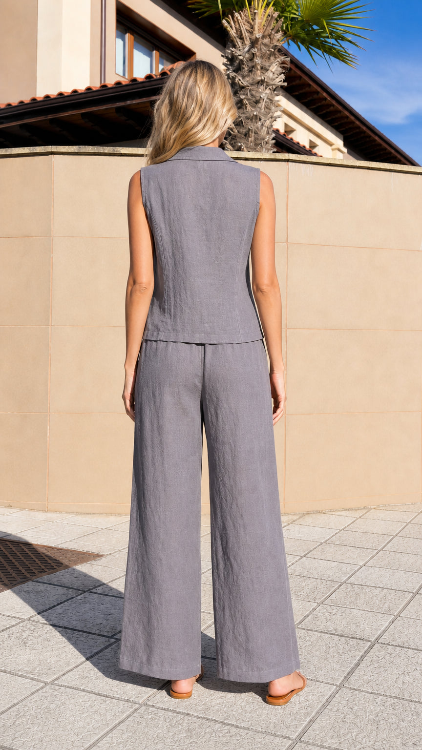 Back view of woman wearing grey vest and trousers set