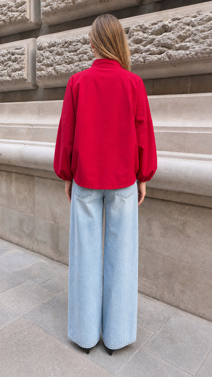 Back view of model showing the relaxed fit of the red lantern sleeve blouse