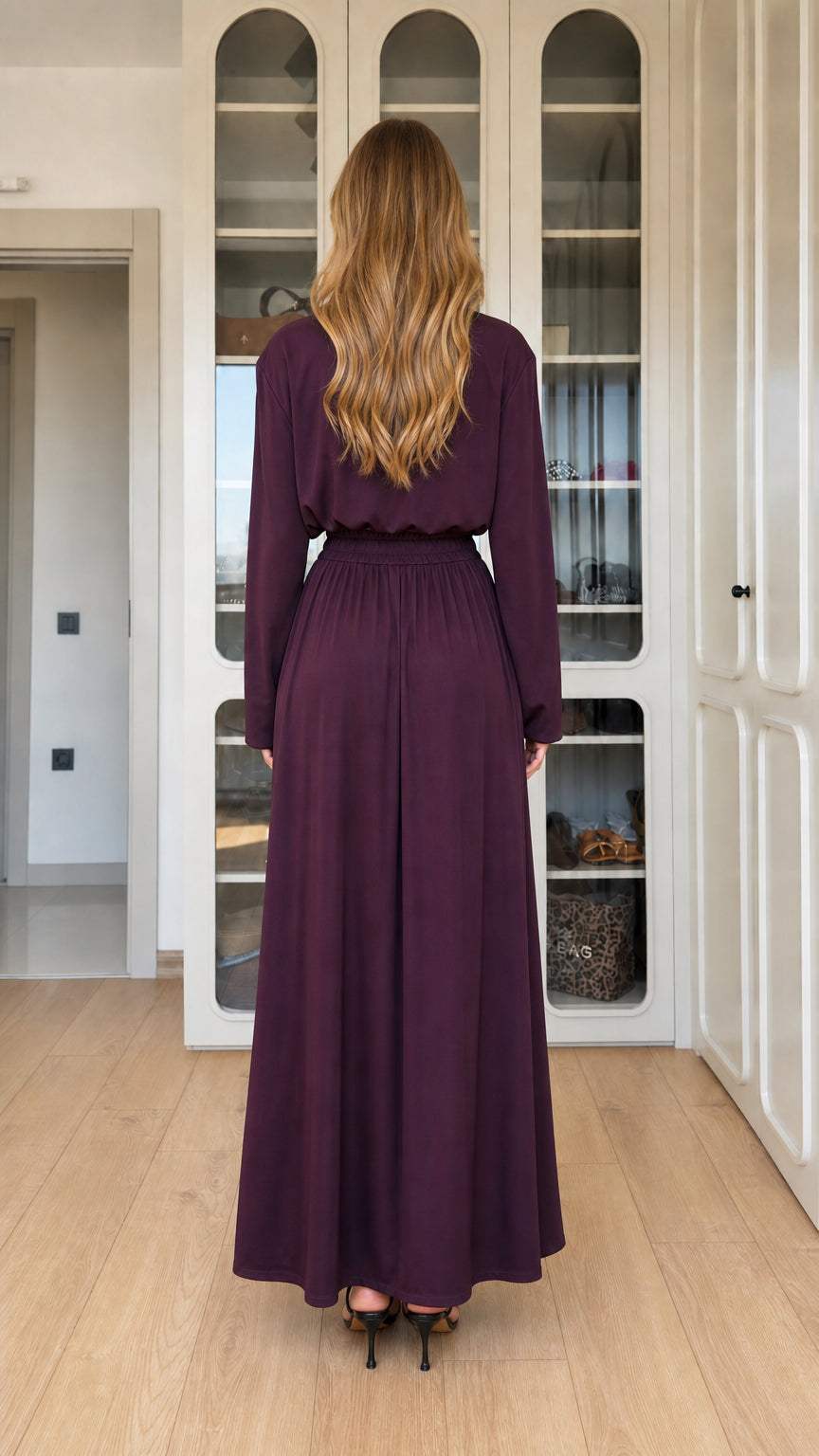 Back full-length view of plum long sleeve high neck top and flowing maxi pants