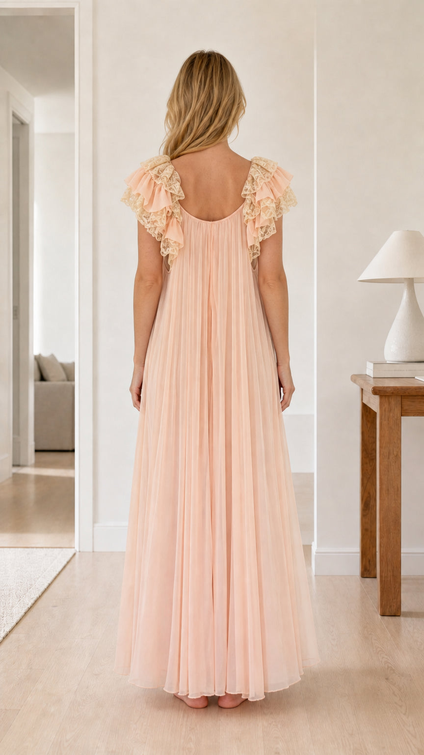Back view of blush pink pleated nightgown showing scoop back and lace cap sleeves