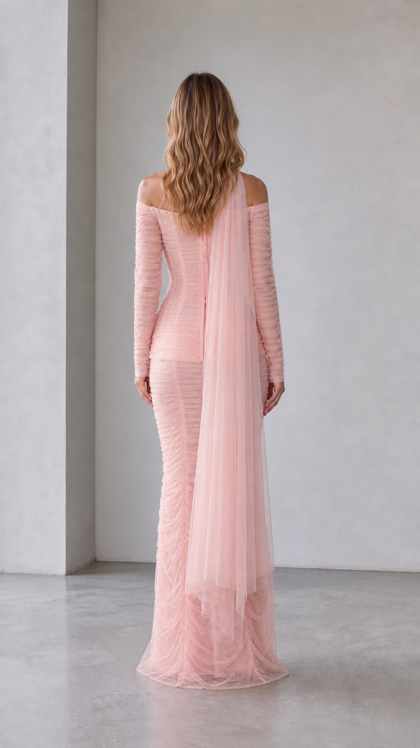 Back view of blush pink off-shoulder mermaid dress with draped tulle panels