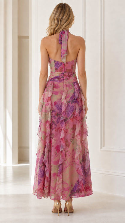 Back view showcasing halter tie and cascading ruffles on pink maxi dress