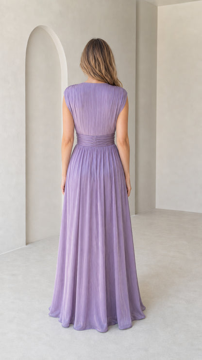 Back view of model wearing lavender pleated maxi dress showing V-back design