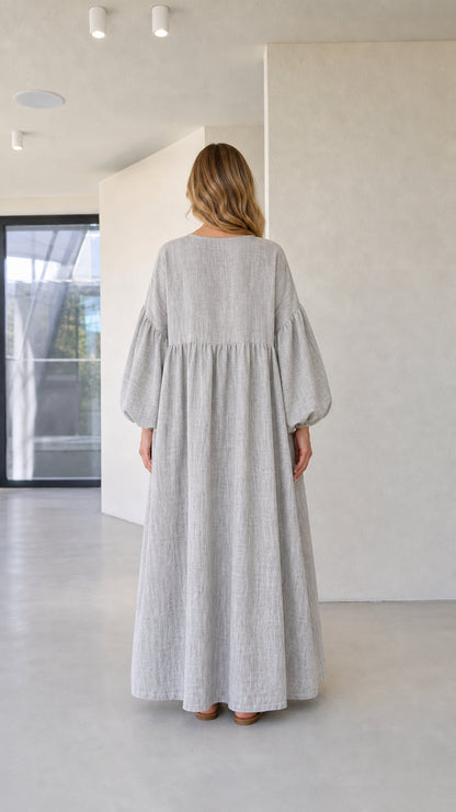 Back view of model wearing grey long sleeve loose-fit maxi dress