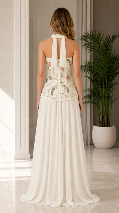 Back view of model showcasing structured corset back and tied neck scarf with ivory maxi dress