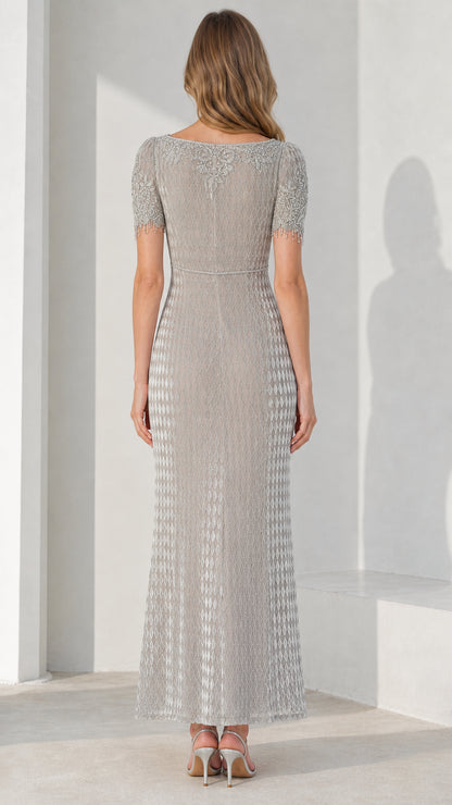 Back view of model showcasing detailed back embroidery on silver gown