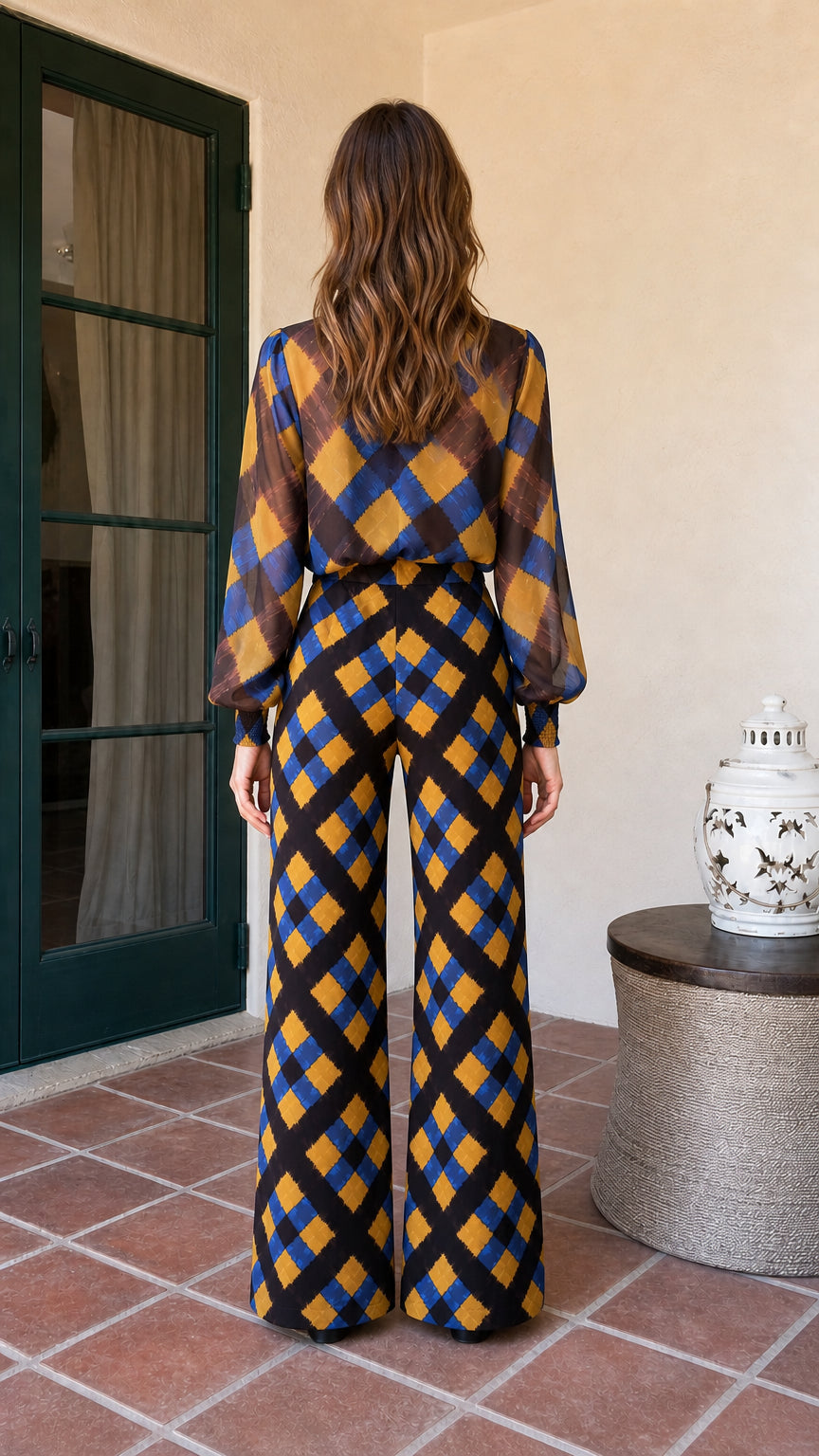 Back view of model showcasing flowing wide-leg trousers and blouse