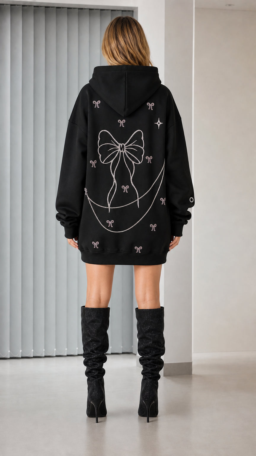 Back view showcasing large rhinestone bow graphic on black hoodie dress