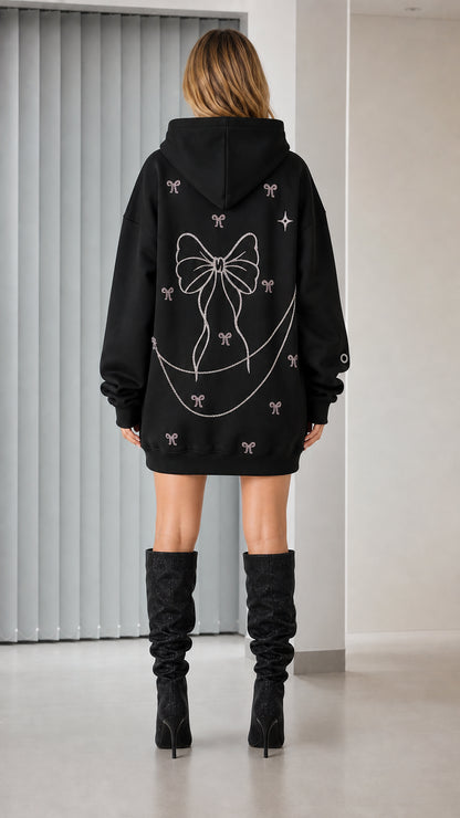 Back view showcasing large rhinestone bow graphic on black hoodie dress