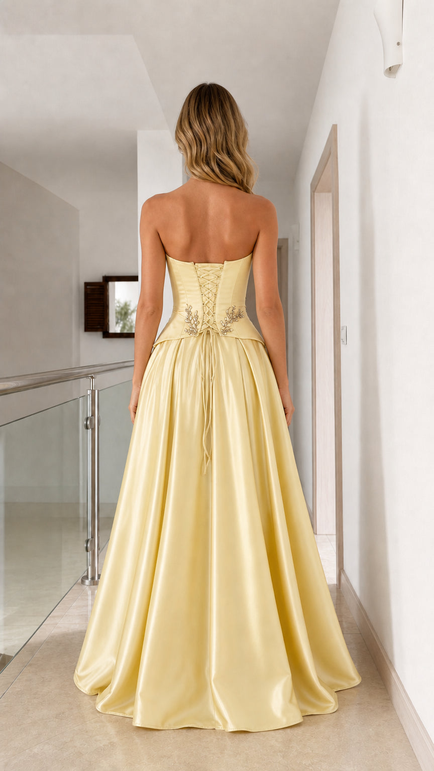 Back view of yellow satin formal gown showcasing adjustable lace-up corset back