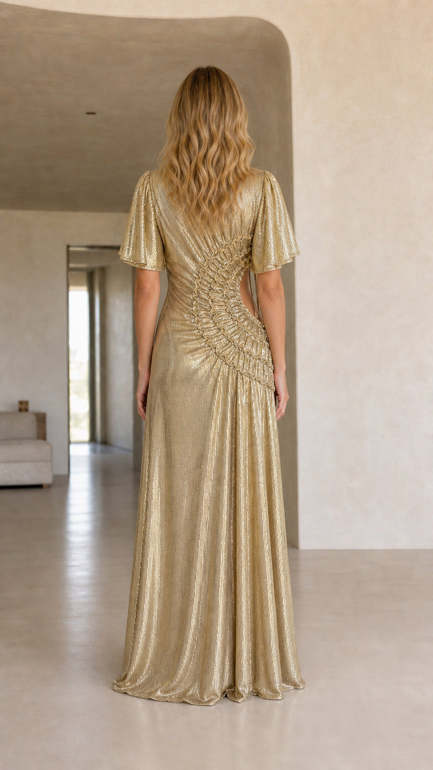 Back view of woman showcasing the fit and drape of the gold maxi dress
