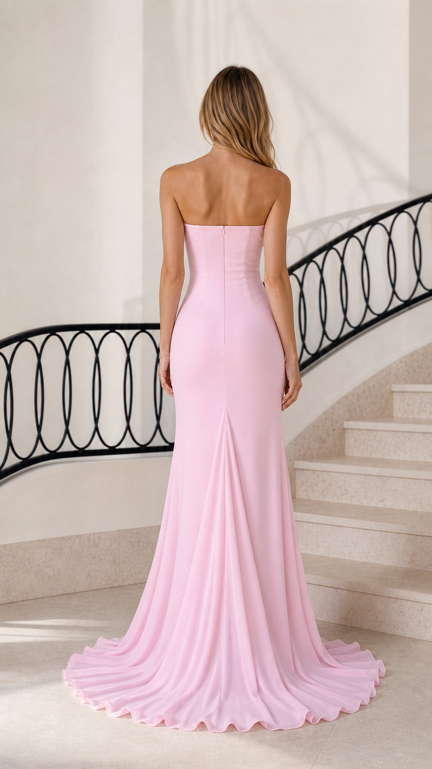Back view of woman showing the clean strapless neckline and floor-sweeping train of pink gown