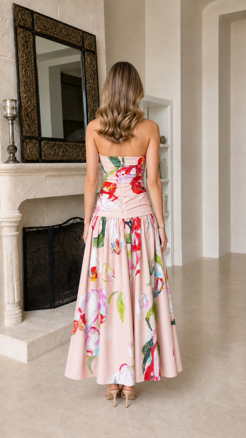 Back view of model in pink floral strapless maxi dress