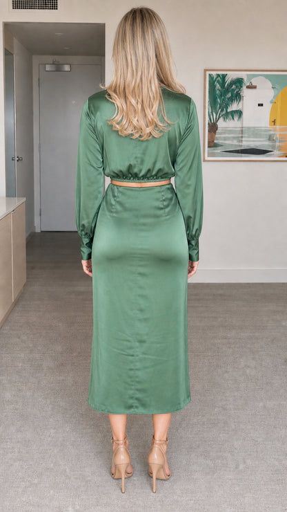 Back view of model in sage green satin matching two-piece set