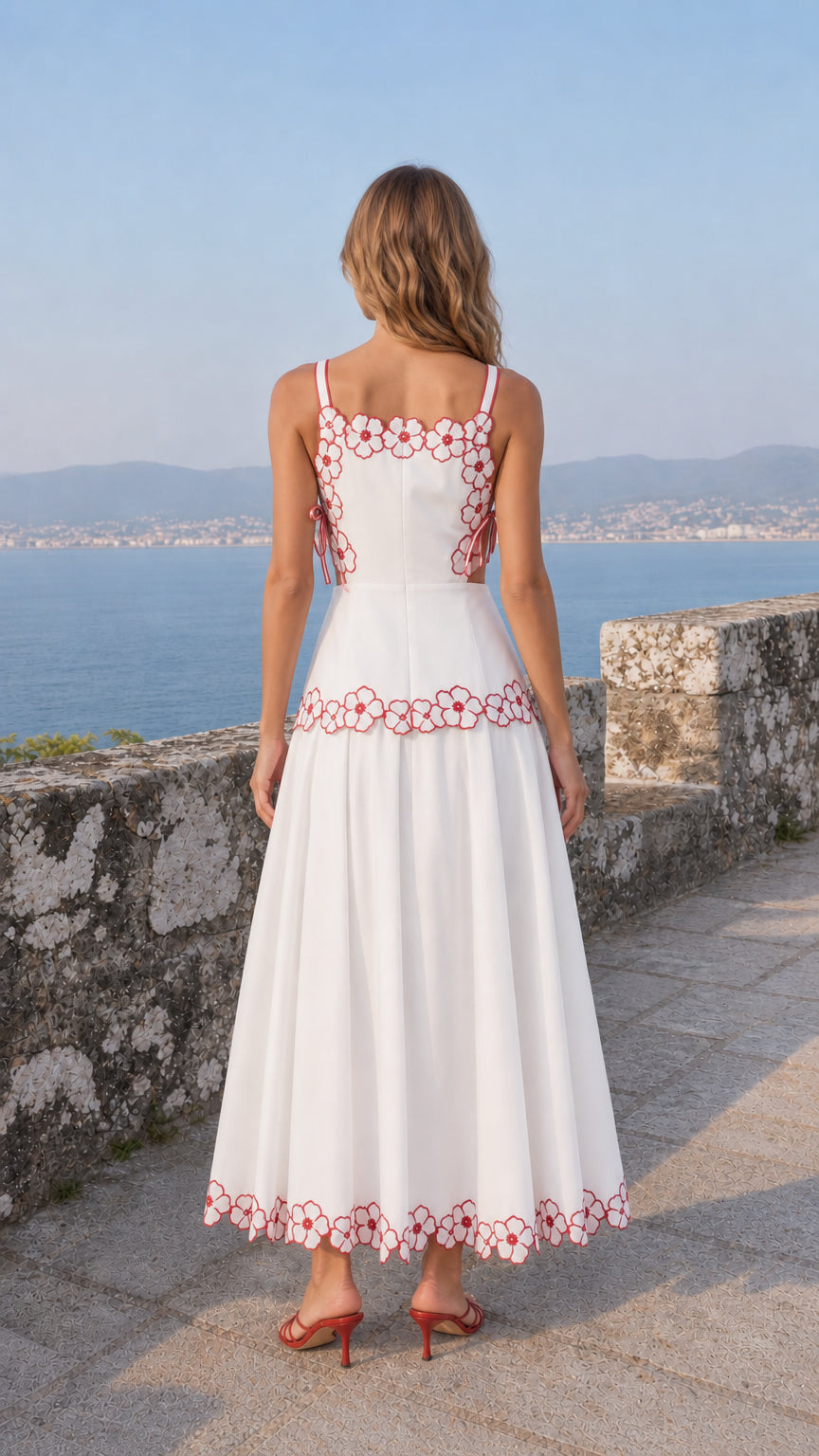 Back view of woman wearing white embroidered midi dress