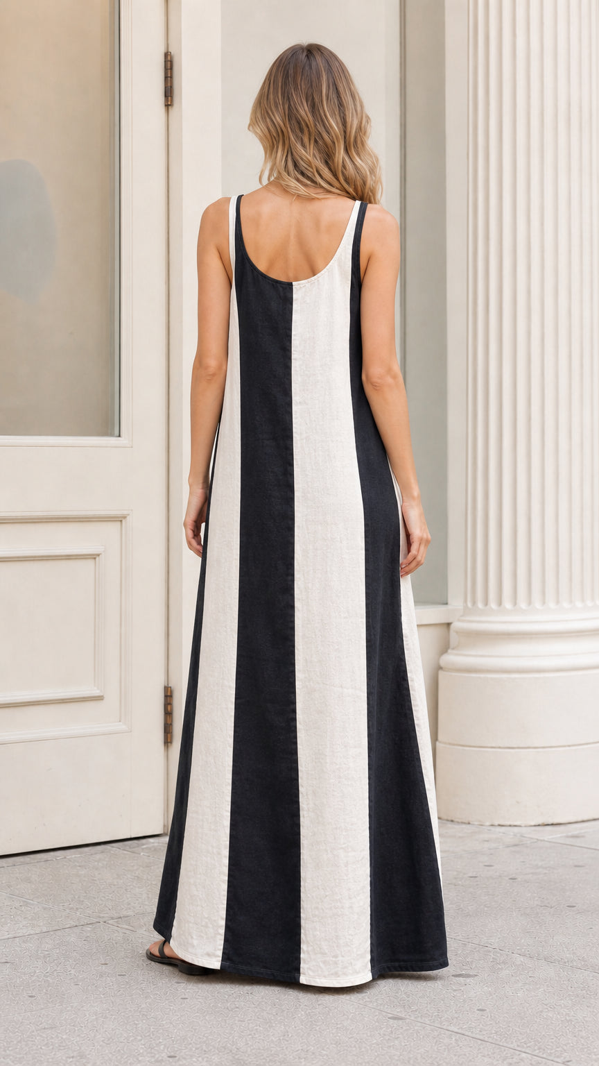 Back view of model wearing black and white color-blocked maxi dress