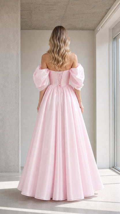 Back view of model showing lace-up detail on pink ball gown