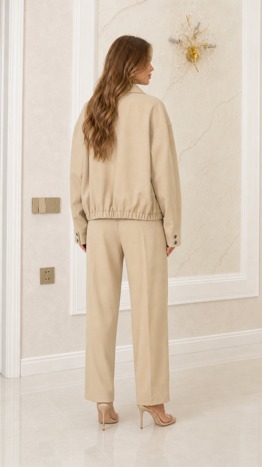 Back view of model in Khaki two-piece set showing elasticated jacket hem and tailored pants