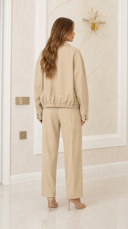 Back view of model in Khaki two-piece set showing elasticated jacket hem and tailored pants
