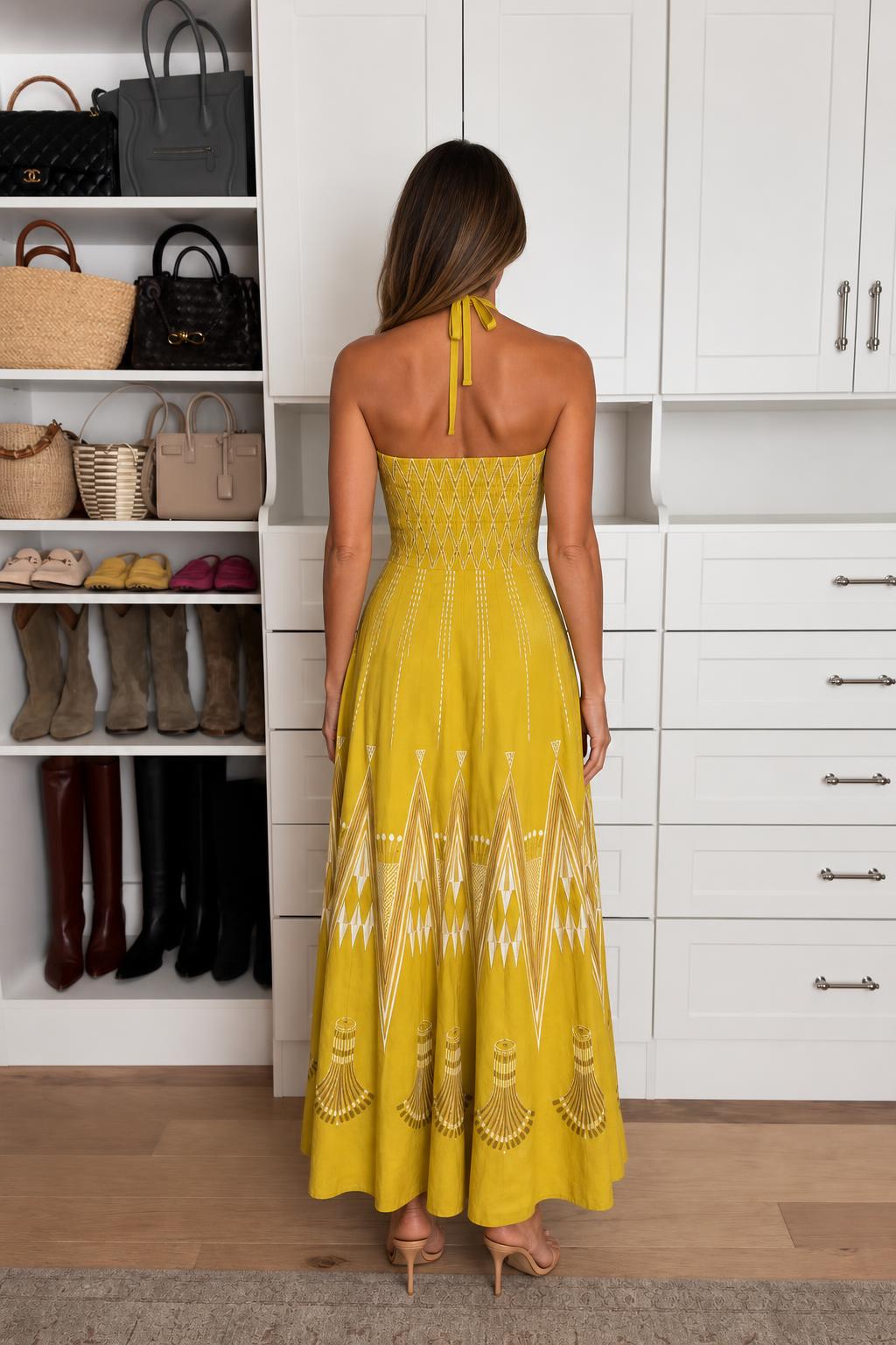 Back view of model wearing Yellow halter neck maxi dress