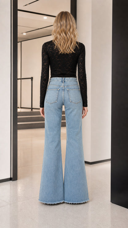 Model wearing black long-sleeve sheer lace top, back view
