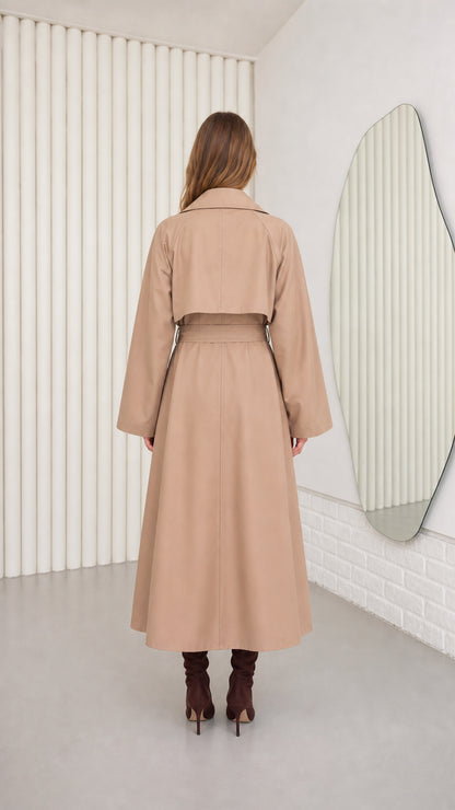 Back view of model in Camel maxi trench coat highlighting storm flap detail