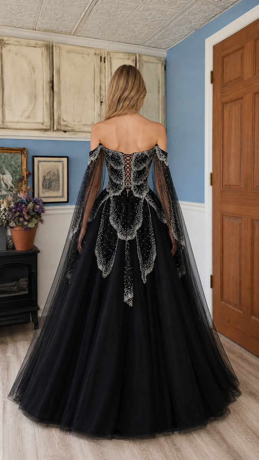 Back view of black ball gown highlighting lace-up corset back and flowing tulle skirt