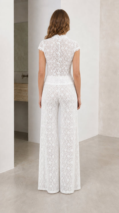 Back view of white lace top and trousers