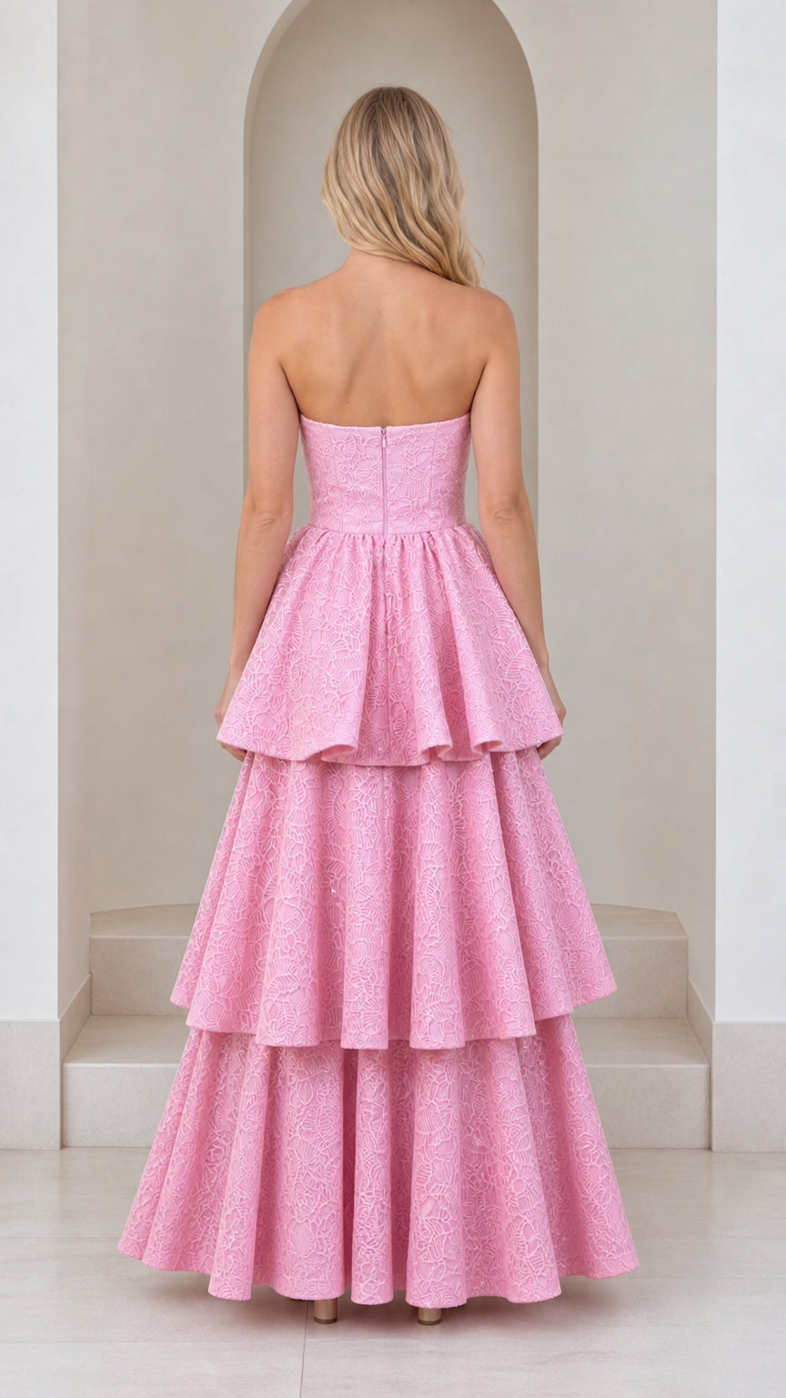 Back view of model showing strapless bodice and tiered skirt