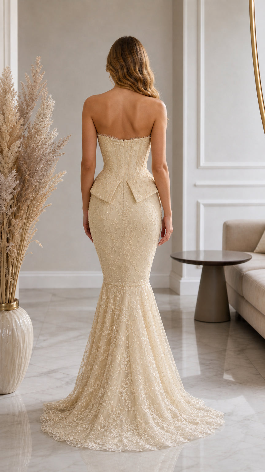 Back view of model in champagne lace corset evening gown with swept train