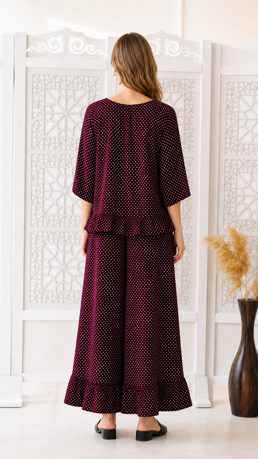Back view of woman modeling burgundy polka dot two-piece co-ord set