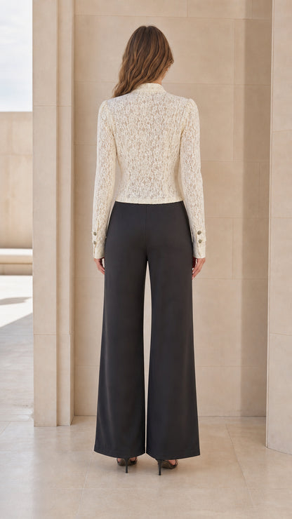 Back view of woman wearing ivory lace jacket