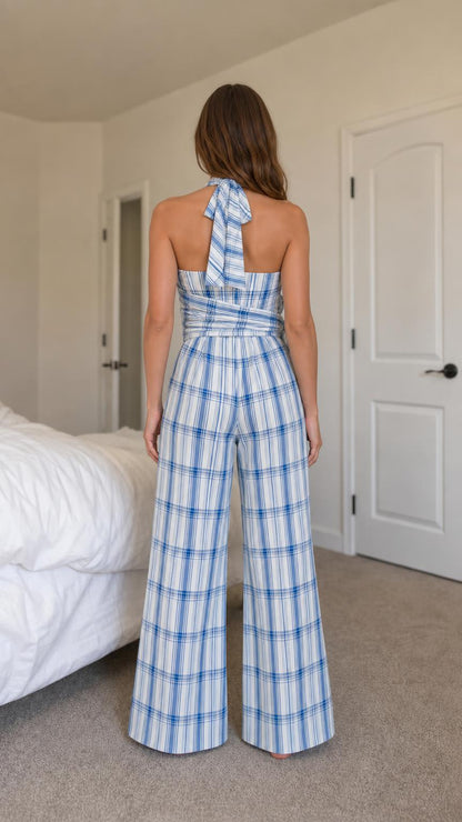 Back view of model showing halter neck tie and blue plaid jumpsuit