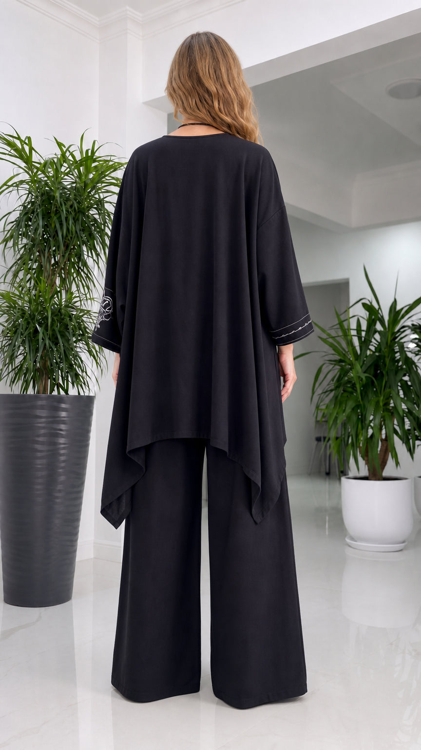 Back view of woman in black tunic and trousers