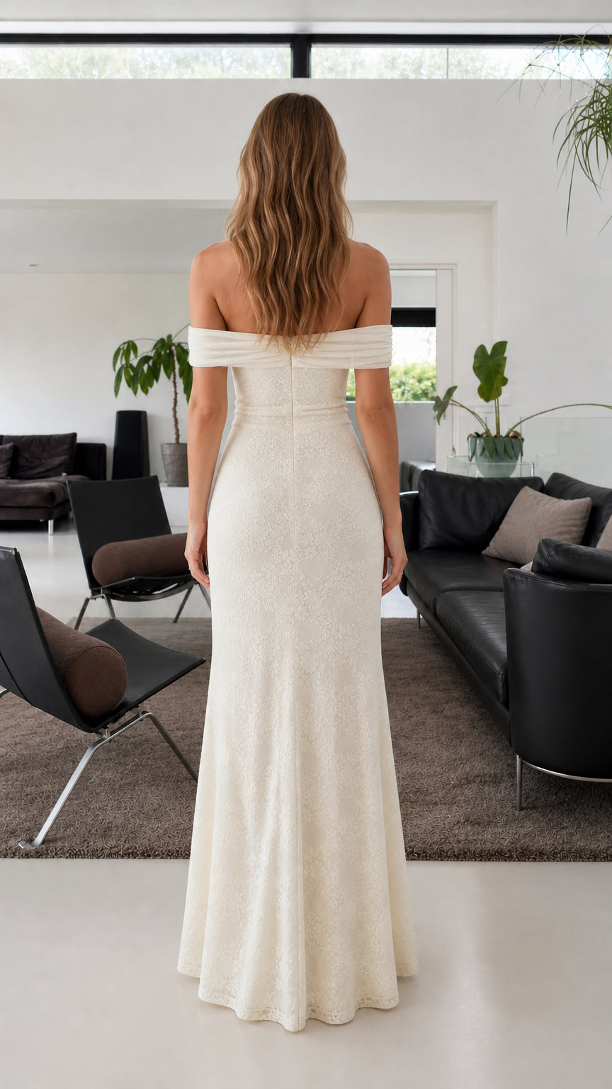 Back view of model in ivory floor-length off-the-shoulder lace evening dress