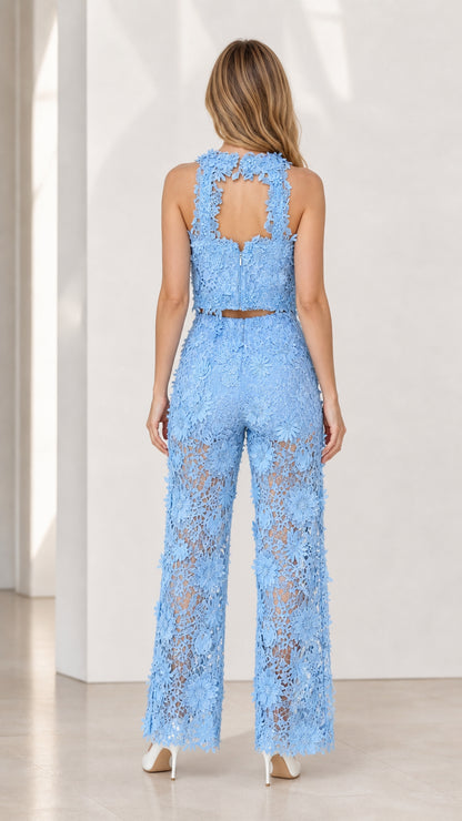 Back view of model showcasing cutout back detail on blue lace top