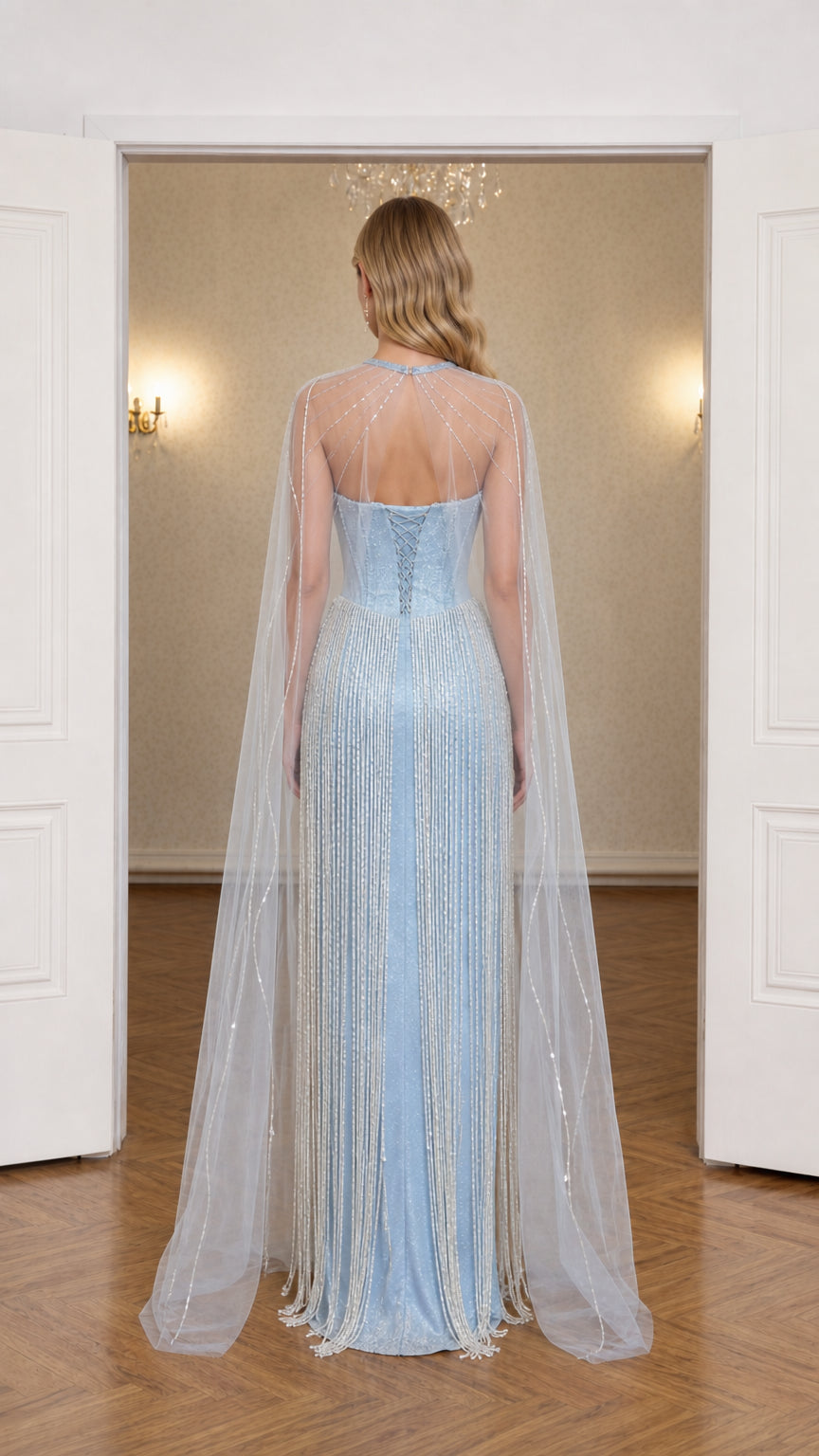 Back view of light blue evening gown highlighting lace-up corset and flowing cape