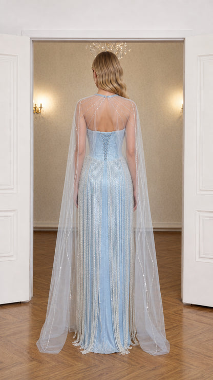 Back view of light blue evening gown highlighting lace-up corset and flowing cape