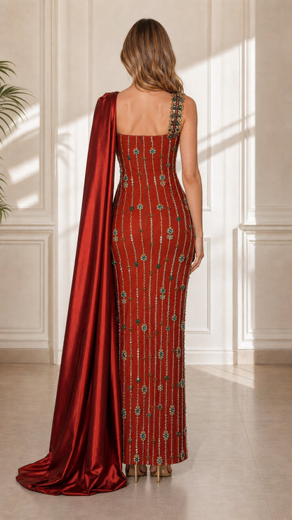 Back view of red formal gown showing long satin cape