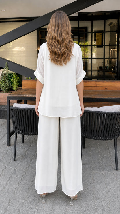 Model wearing white layered tunic set, back view