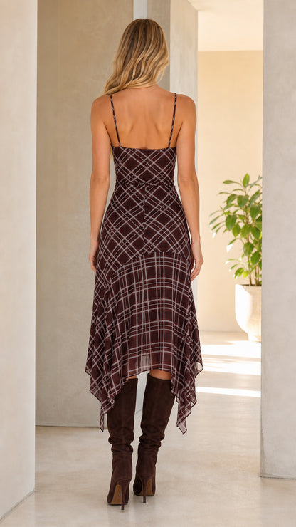 Back view of woman wearing brown plaid midi dress with spaghetti straps
