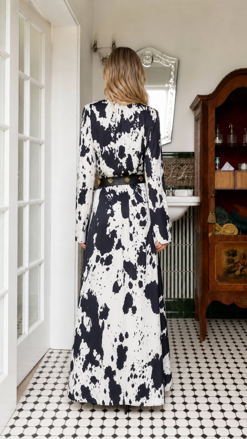 Back view of woman wearing white cow print maxi dress