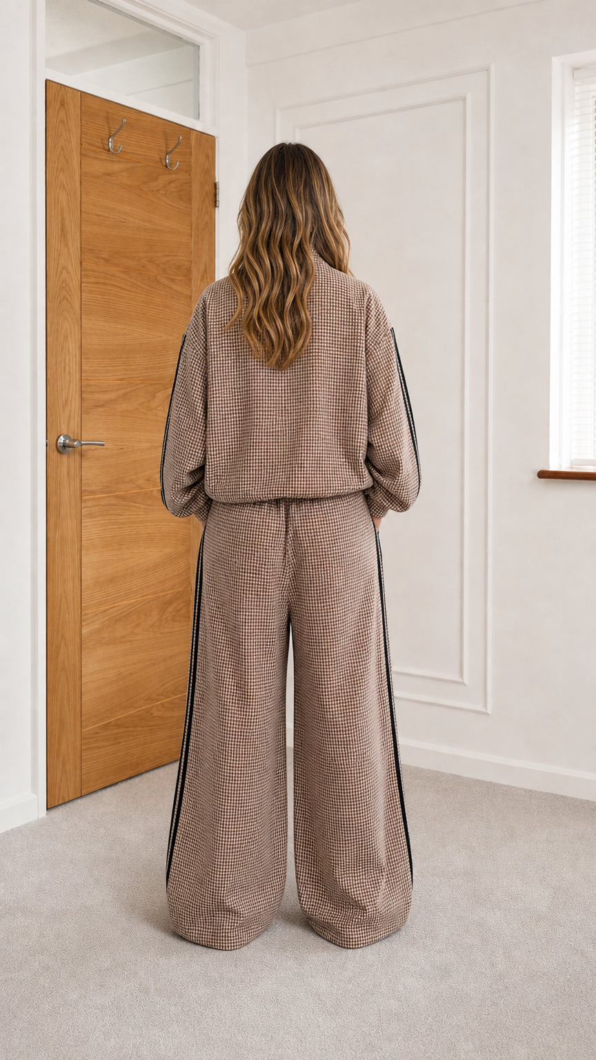 Back view of model wearing camel houndstooth track set
