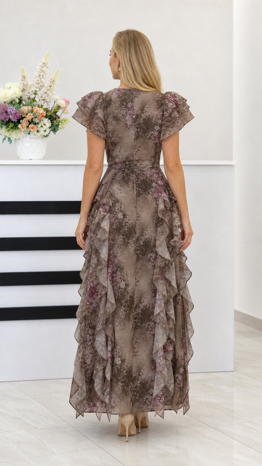 Back view of taupe floral ruffle maxi dress with layered skirt