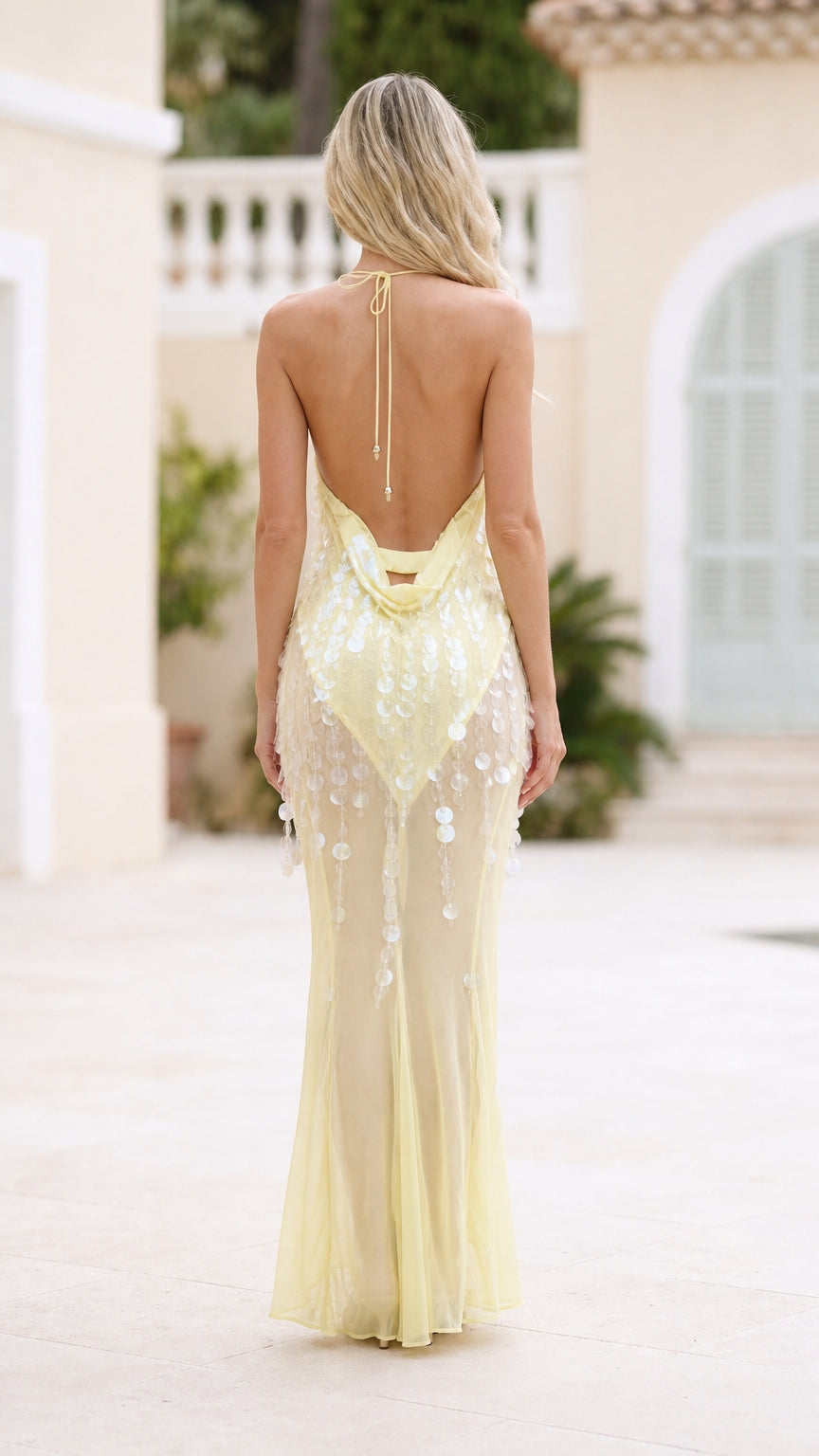Back view of yellow sequin halter maxi dress